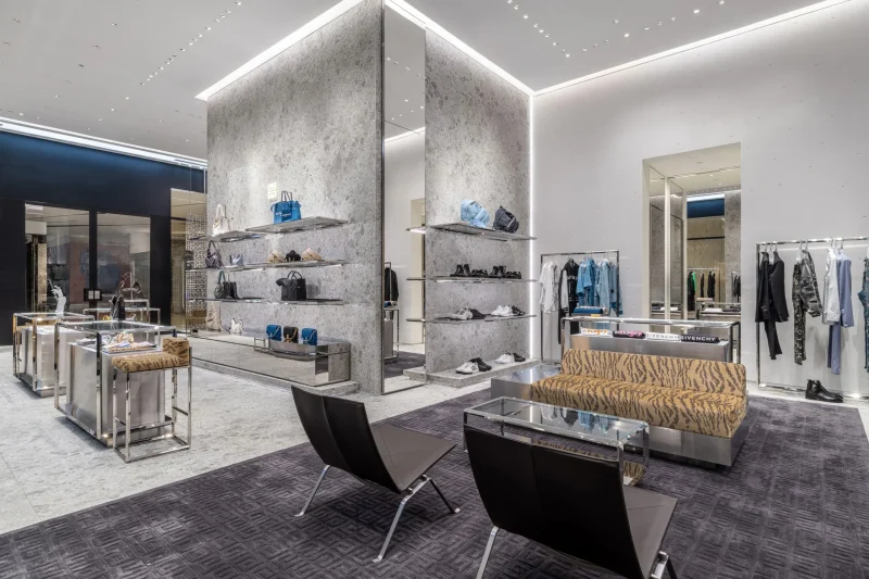Givenchy Siam Paragon interior with tiger-print lounge seating, display shelves, and menswear racks