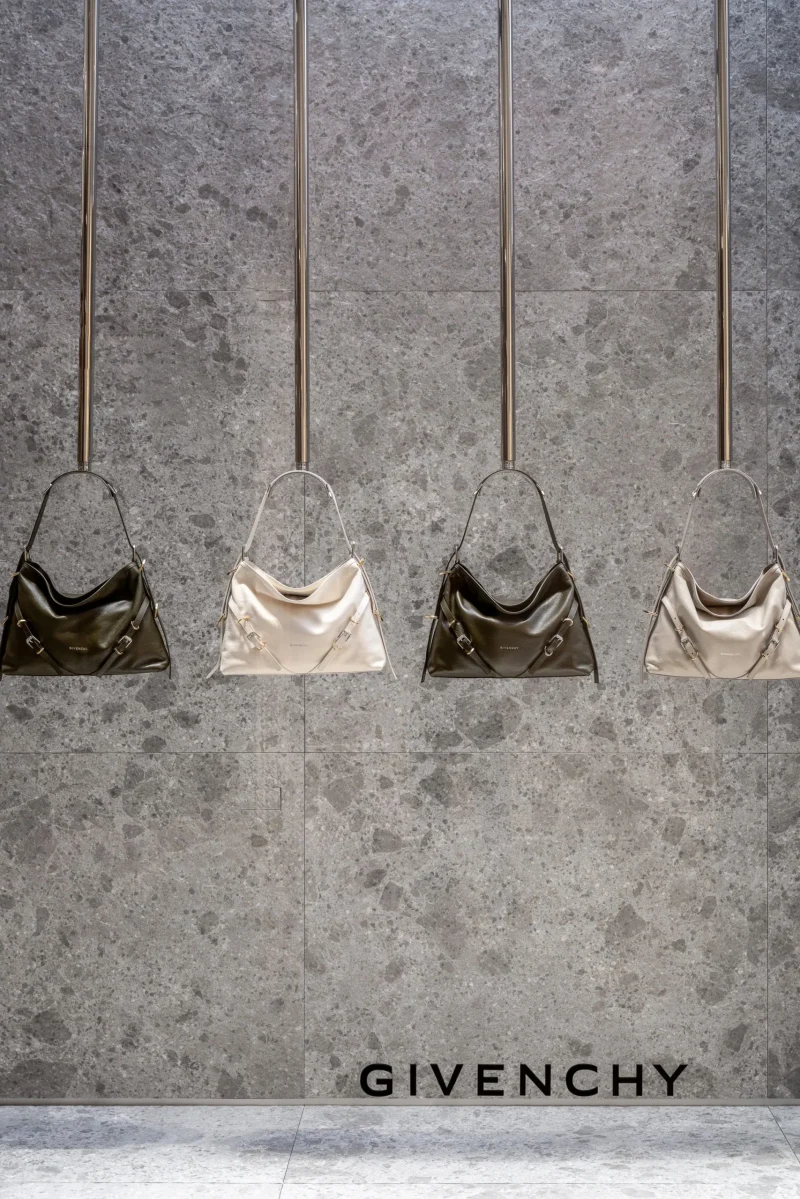 Four Givenchy handbags hanging in a window display at Givenchy Siam Paragon