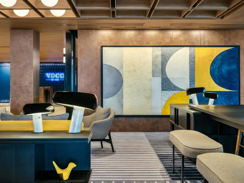 voco Surawong lobby lounge with abstract wall art, mushroom lamps, and yellow bird ornament