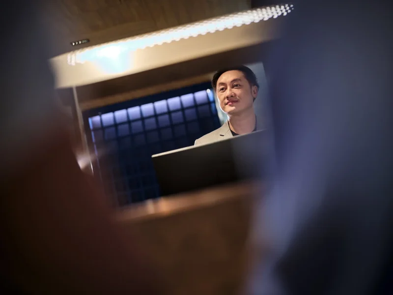 Luxury hotel photographer Bangkok — front desk staff at voco Surawong reception