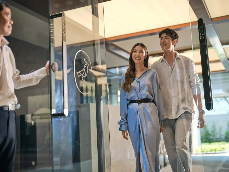Hotel photography Bangkok — couple arriving at voco Surawong hotel entrance